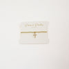 A timeless 14K gold-plated beaded bracelet featuring a minimalist cross charm for a touch of faith and elegance.
