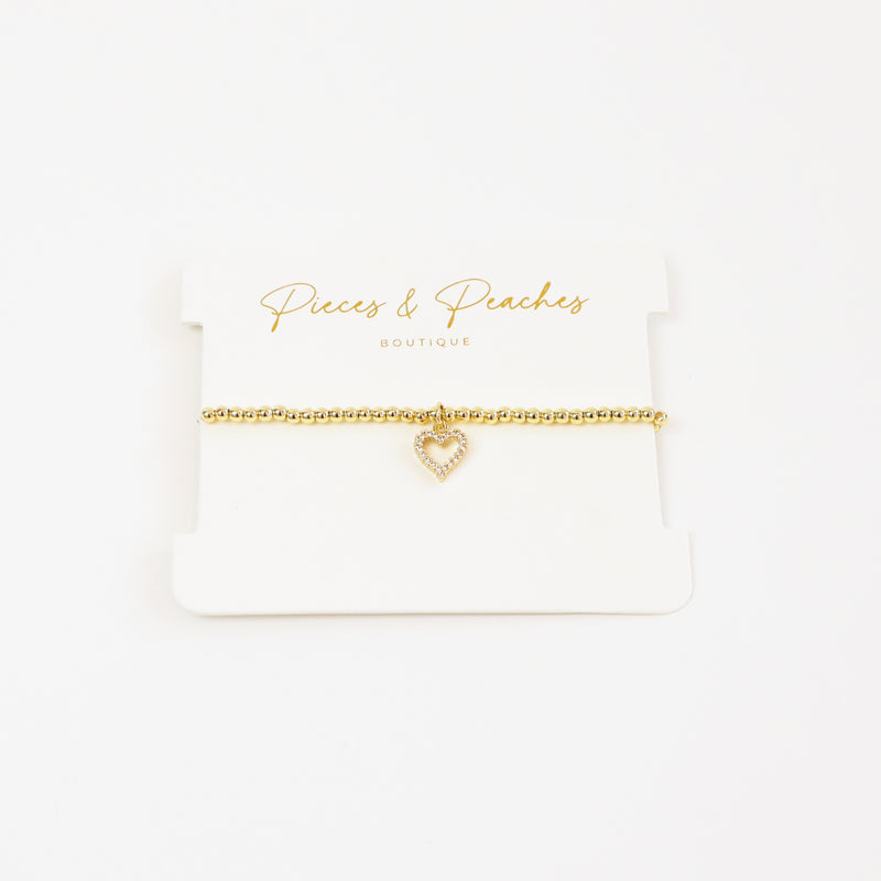 A chic and meaningful 14K gold-plated bracelet with 3mm beads and a classic heart charm, symbolizing love and connection.