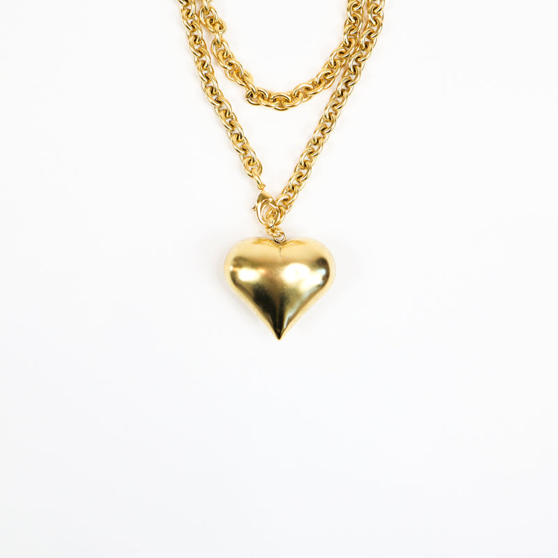 A handcrafted 22K gold-plated statement necklace featuring a bold, oversized heart pendant suspended from a chunky gold chain, exuding elegance and confidence.