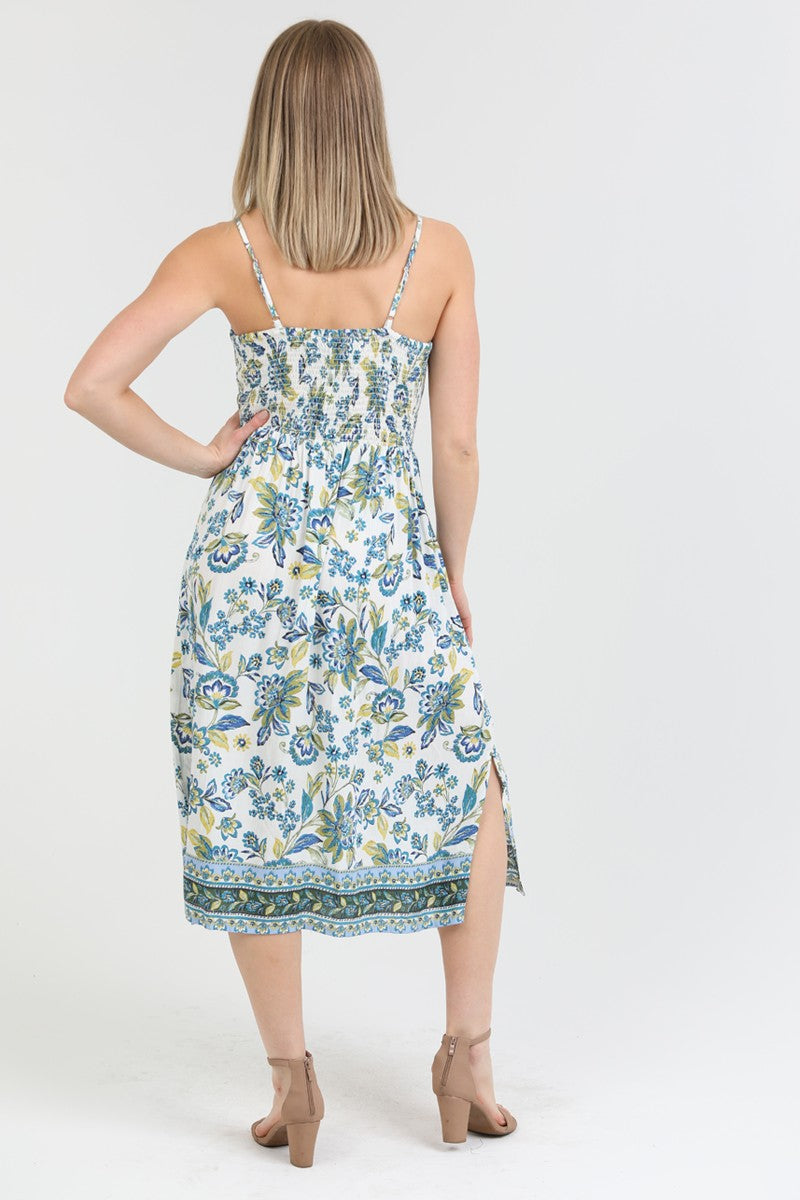 floral midi dress with a twist-front bodice, adjustable straps, and side slit, styled for a summer look.