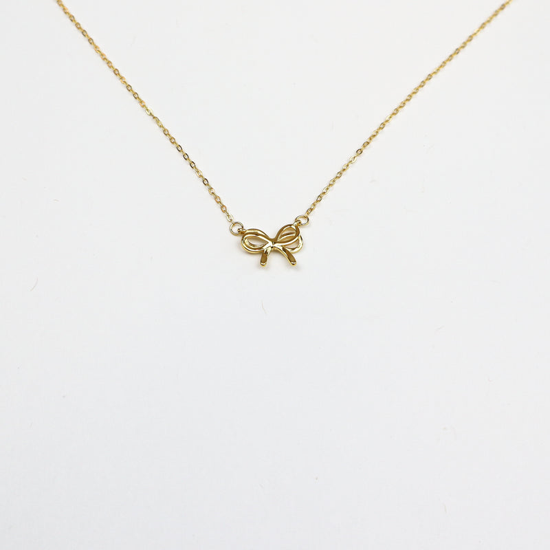 Elegant Dainty Bow Necklace featuring a delicate gold-plated bow pendant on a fine adjustable chain, perfect for minimalistic and sophisticated styling.