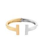 Two-tone cuff bracelet featuring a sleek open-ended design with gold and silver finishes, perfect for modern minimalist styling
