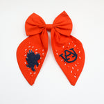 Go Team Bow - Oversized collegiate-style bow in auburn team colors, perfect for game days, tailgates, and spirited outfits. Features a sturdy alligator clip for secure wear.