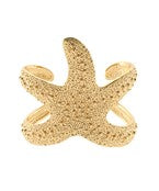 Gold starfish cuff bracelet featuring a textured sculptural design, inspired by the beauty of the ocean for a bold and elegant statement look