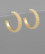 Gold hoop earrings with delicate pearl accents