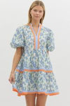 Close-up of Sarah Dress in blue floral with contrast trim, highlighting lightweight cotton fabric and pockets.