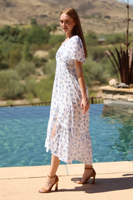  blue floral maxi dress with flutter sleeves and a front slit